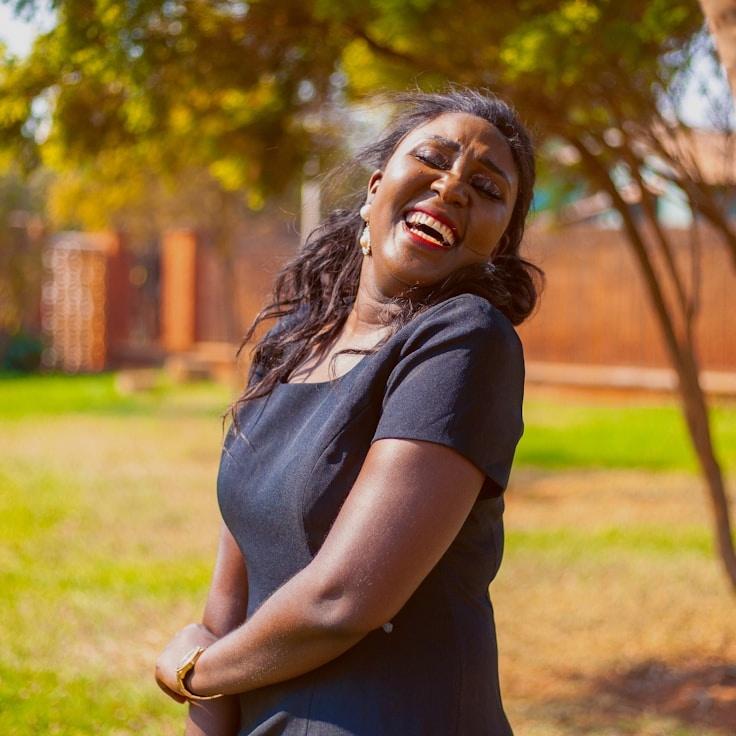 Maya Chen, Lead Design Curator at River Golden Sphere, reviewing corporate floral arrangements